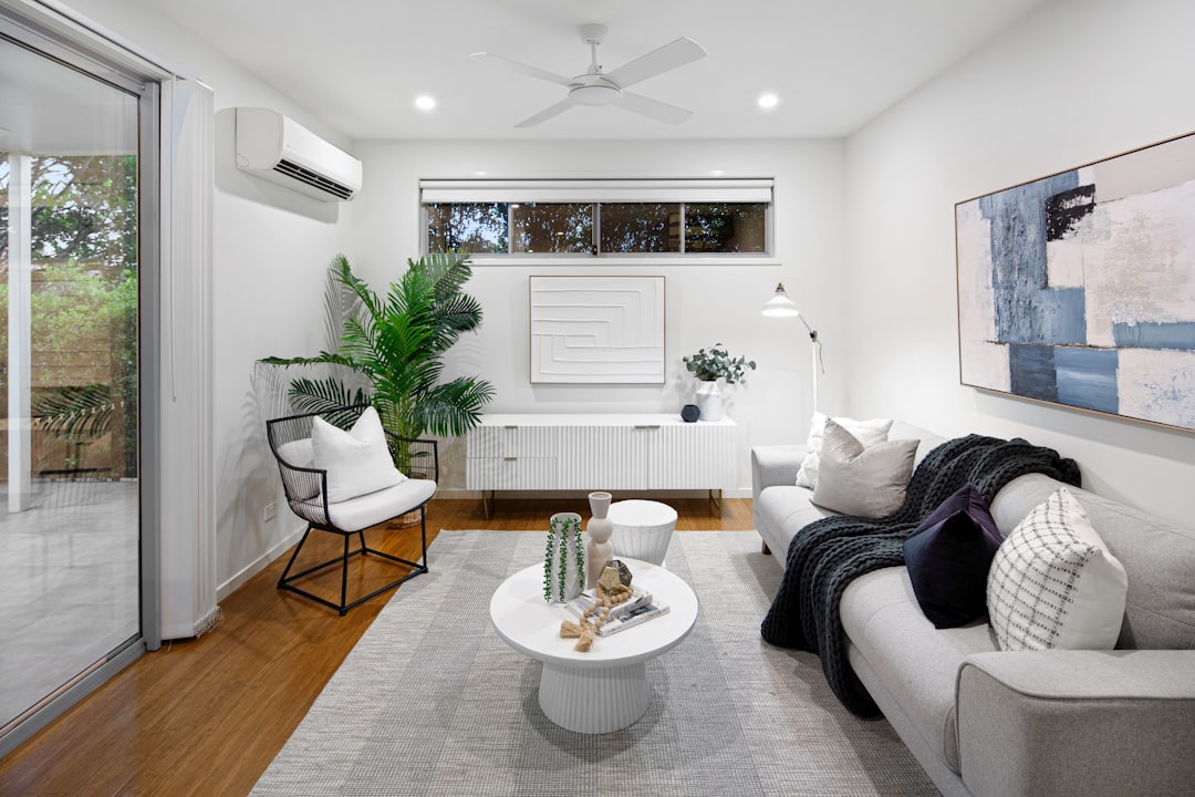 Homeowner adjusting a smart thermostat in a bright, comfortable home